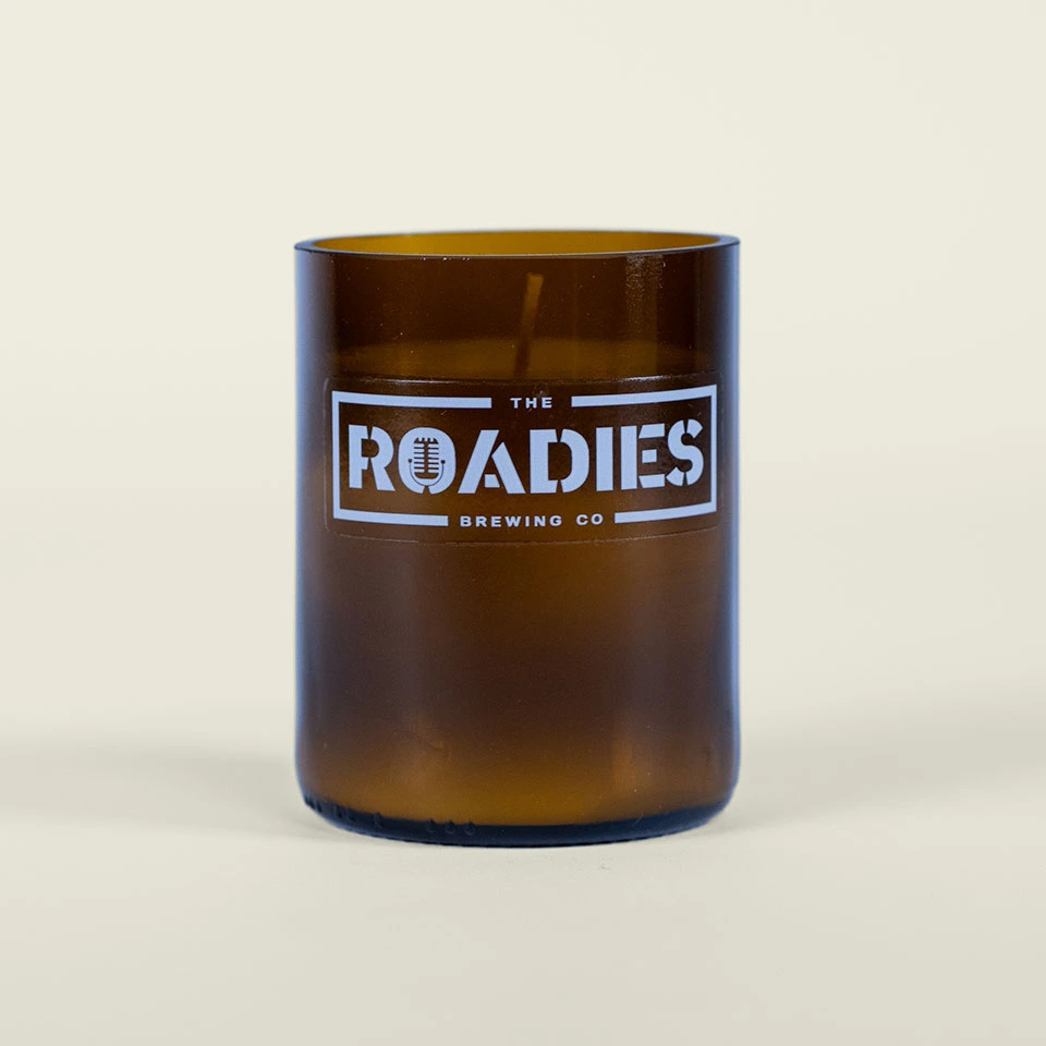 Logo-Candle Brown glass candle with the words The Roadies on it