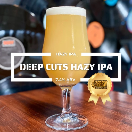 Glass of Deep Cuts Hazy IPA on a counter at the roadies brewing co. in vista CA